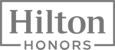 This image shows the logo for Hilton Honors, a rewards program for Hilton Hotel guests.